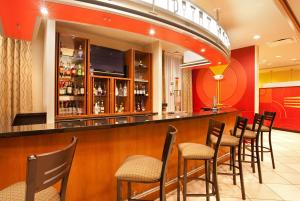 a bar in a restaurant with a bunch of chairs at Holiday Inn Aurora North - Naperville, an IHG Hotel in Aurora