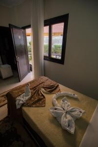 a bedroom with a bed with towels on it at Sand Beach Resort in Hurghada