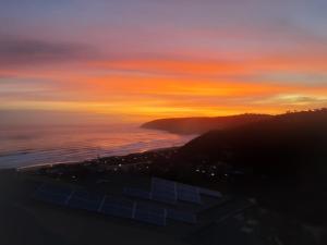 a sunset over the ocean with the sky at Bly-Uitzicht in Wilderness