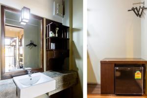 
a bathroom with a sink and a mirror at Le Canal Boutique House in Chiang Mai
