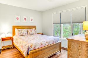 a bedroom with a bed and two windows at Night Heron 4117 in Kiawah Island