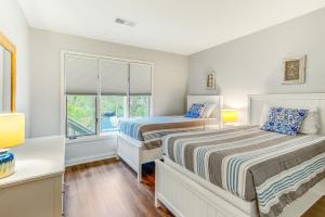 a bedroom with two beds and a window at Night Heron 4117 in Kiawah Island +17 photos