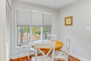 a dining room with a table and chairs and a window at Night Heron 4117 in Kiawah Island