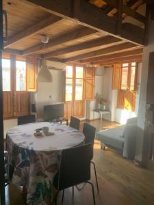 a room with a table and chairs and a couch at Sampedor Apartment in Valencia