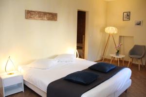 ein Schlafzimmer mit einem großen weißen Bett mit blauen Kissen in der Unterkunft Appart'Hôtel Residence Dizerens in Genf