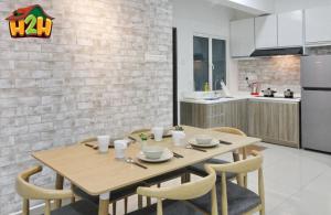 a kitchen with a wooden table and chairs in a room at H2H - Neo Casual - Majestic Ipoh Town Center - 8pax in Ipoh