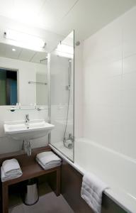 a bathroom with a sink and a shower at Kyriad Hôtel Orly Aéroport - Athis Mons in Athis-Mons
