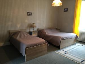 En eller flere senge i et værelse på La Ferme Antoinette