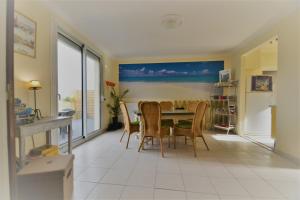 a kitchen and dining room with a table and chairs at Ty Ana in Ploubazlanec