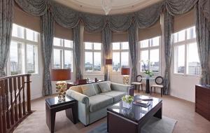 a living room filled with furniture and a window at The Royal Horseguards in London