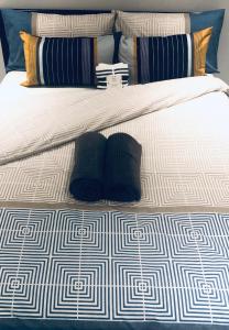 a bed with two pillows on it with at Ultra Modern Room in Croydon +4 photos