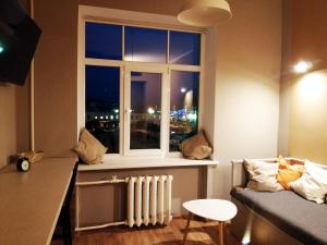 a room with a window with a radiator and a couch at Vienibas 11 in Daugavpils