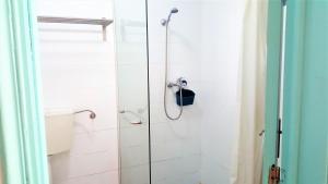 a shower with a glass door in a bathroom at Patio Beach House - Checkinhome in Castro Marim +34 photos