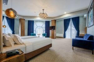 a bedroom with a large bed and a large window at Corner Hotel Tashkent in Tashkent