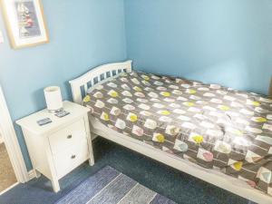 a small bedroom with a bed and a night stand at 9 Swallow Court in Herne