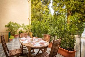 a wooden table and chairs on a patio at Cernobbio Town House in Cernobbio