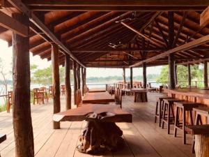 a row of tables and chairs in a wooden building at Stung Treng Resort in Stœ̆ng Trêng