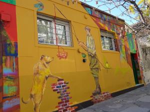 a painting of a building with graffiti on it at Palermo Viejo Bed & Breakfast in Buenos Aires