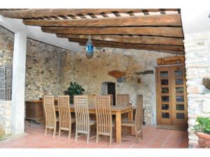 a wooden table and chairs on a patio at La Isla Verde in Els Hostalets