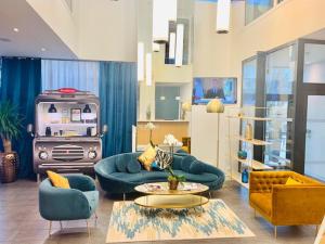 a living room with blue furniture and a stove at Residhome Nanterre La Défense in Nanterre