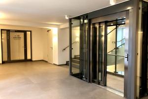 an empty room with glass doors in a building at Ferienwohnung Aquamarin im Haus Arkona in Binz