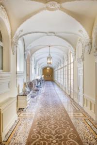 an ornate corridor in a building with a long hallway at H&ocirc;tel Hermitage Monte-Carlo in Monte Carlo