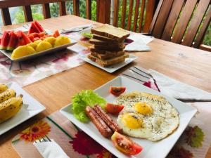 a table with two plates of breakfast food on it at Inspira ella in Ella
