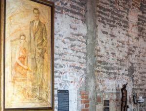 a painting of a man and a woman on a wall at Hotel Hacienda San Cristóbal in León