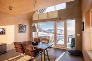 una sala da pranzo con tavolo, sedie e finestra di Viking Cottages & Apartments ad Akureyri