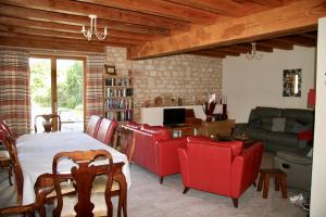 a living room with a table and chairs and a couch at Loire Escapes in Berrie