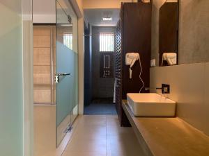 a bathroom with a sink and a glass shower at Handagedara Resort & Spa in Mirissa