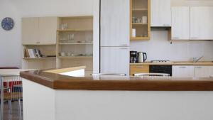 a kitchen with white cabinets and a counter top at Brama Village in Aprilia Marittima