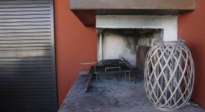 a room with two chairs and a wall with a fireplace at Brama Village in Aprilia Marittima