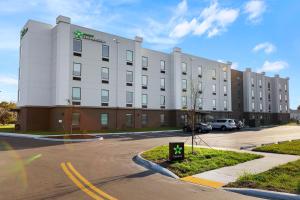 a large white building in a parking lot at Extended Stay America Premier Suites - Titusville - Space Center in Titusville