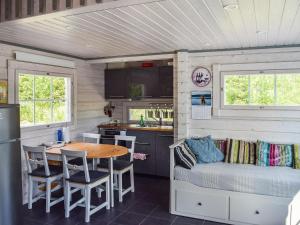 a kitchen and dining area of a tiny house at Holiday Home Lekojärven herra by Interhome in Räihä