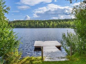 a dock in the middle of a large lake at Holiday Home Lekojärven herra by Interhome in Räihä