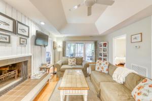 a living room with a couch and a fireplace at 1038 Sparrow Pond in Kiawah Island