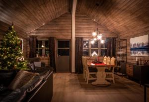a living room with a christmas tree and a table at Cabin in Hodlekve with 5 bedrooms & hot tub. in Sogndal