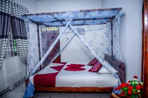 a bed with a canopy in a room at Nehansa Resort and safari in Tissamaharama