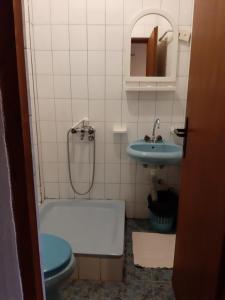 a bathroom with a tub and a toilet and a sink at Šumatovac in Aleksinac