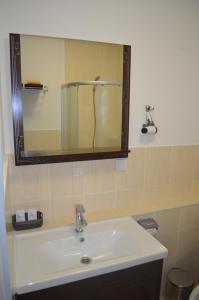 a bathroom with a white sink and a mirror at Motel Chalet in Vita-Pochtovaya