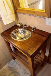 a sink on a wooden table in a bathroom at Casa Del Sol in Villa La Angostura +26 photos