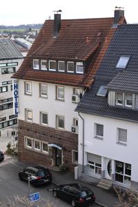 a building with cars parked in a parking lot at BB City Hotel in Böblingen
