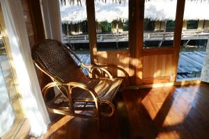 two chairs sitting on the porch of a house at Baan​ Tonlamphu​ Pakpra in Phatthalung