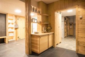 a kitchen with wooden walls and a counter with a sink at Hotel Zum Hirsch in Römhild