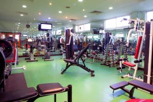 a gym with a lot of machines in it at Landmark Hotel in Dubai