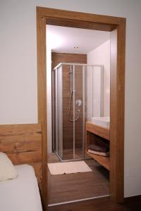 a shower with a glass door in a bedroom at Freihaushof in Mayrhofen