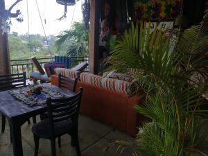 un tavolo e delle sedie in una stanza con delle piante di Tiki bar hostel ella a Ella