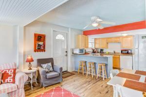 a kitchen and living room with a table and chairs at The Folly House in Folly Beach