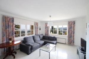 ein Wohnzimmer mit einem Sofa und einem Tisch in der Unterkunft Club Villamar - Citron in Calonge